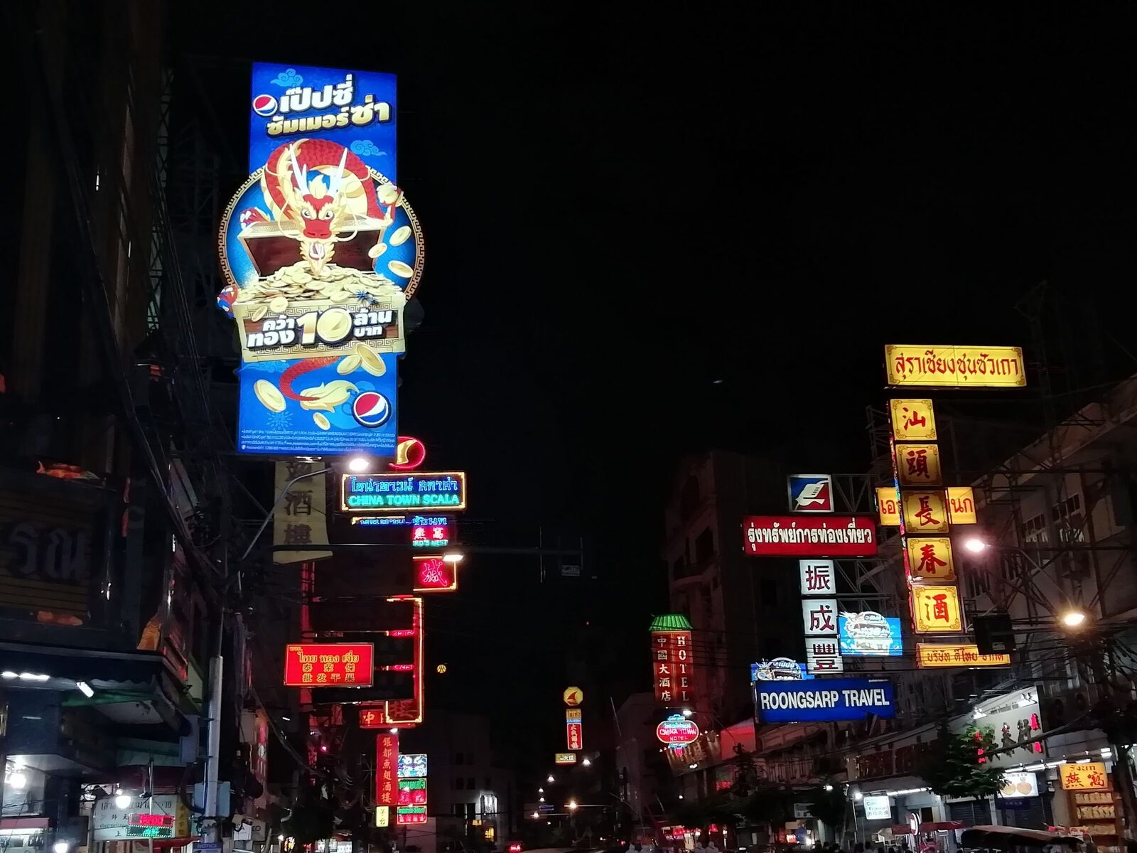 Pepsi neon dragon sign amid the layered neon of Bangkok Chinatown at night