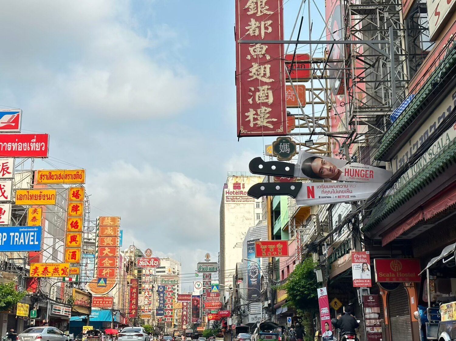Netflix Hunger hanging cleaver sign among the neon of Bangkok Chinatown